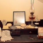 Sugden Family dresser with women's accessories and sampler.